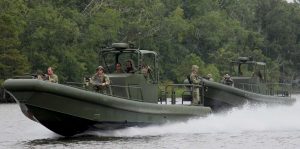 Silver Ships riverine patrol boats with soldiers in the jungle