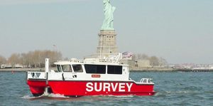 Silver Ships survey boat in front of Statue of Liberty