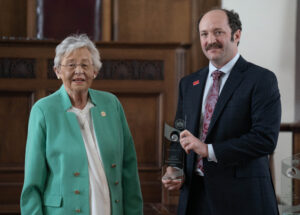 Steven Clarke receiving award from Kay Ivey.